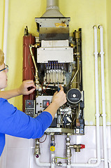Image showing plumber heating screwdriver