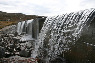 Image showing water flows out of the dam on the Hardangervidda in Norway