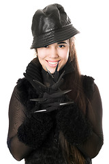 Image showing Portrait of smiling young brunette in gloves with claws