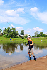 Image showing boy fishes on coast river