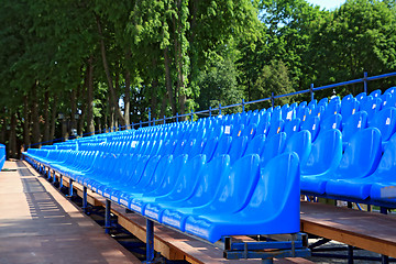 Image showing blue easy chairs on stadium