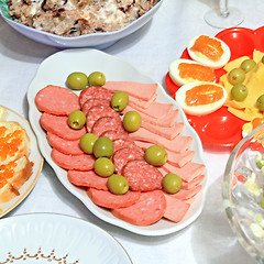 Image showing varied food-stuffs on white tablecloth