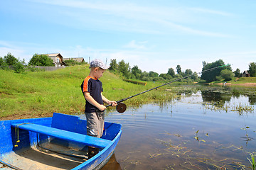 Image showing boy fishes on coast river