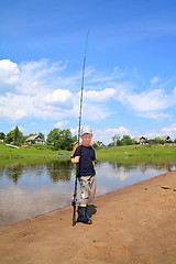 Image showing boy fishes on small river