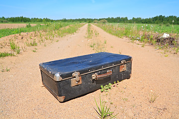 Image showing old valise on rural road