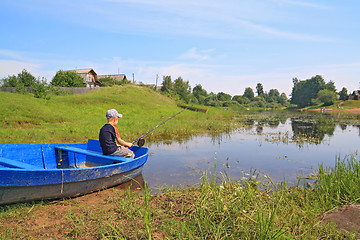 Image showing boy fishes on coast river