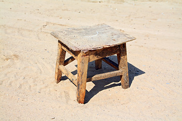 Image showing old stool on sandy road