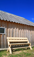 Image showing wooden bench near wooden wall