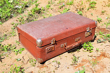 Image showing old valise on yellow sand