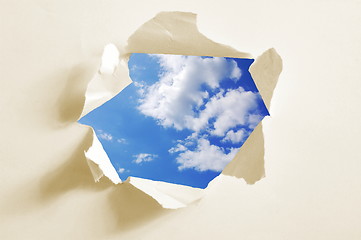 Image showing cloudy sky behind paper hole