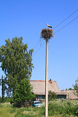 Image showing crane on pole amongst villages