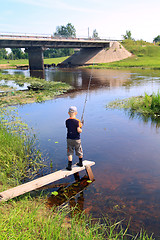 Image showing boy fishes on small river