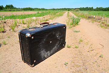 Image showing old valise on rural road