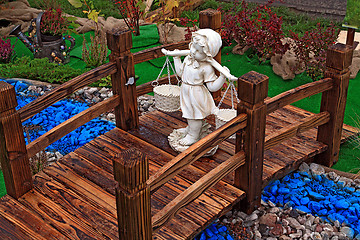 Image showing girl carries baskets through bridge