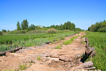 Image showing rural wooden äîðîíà through marsh