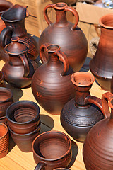 Image showing clay pitchers on yellow background