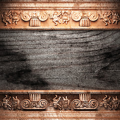 Image showing golden ornament on wood