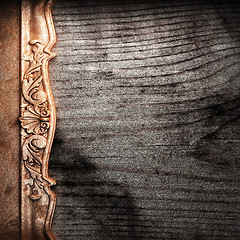 Image showing golden ornament on wood