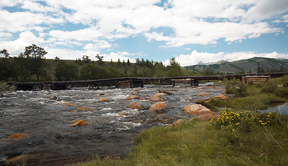 Image showing Wooden bridge over river