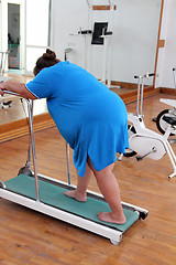 Image showing overweight woman running on trainer treadmill