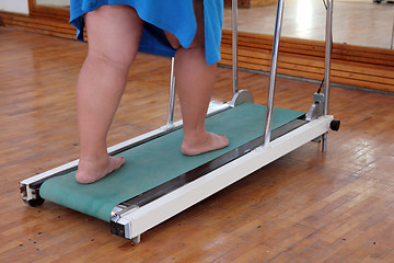 Image showing overweight woman legs on trainer treadmill