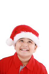 Image showing Cute little boy in Santa hat, looking up to copy space 