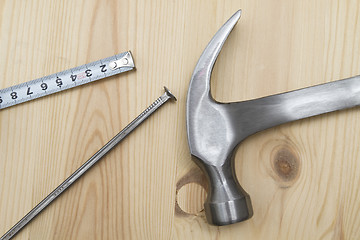 Image showing Old hammer , tape measure and nail