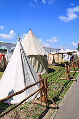 Image showing white tents near ancient wall