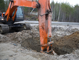 Image showing Backhoe digging trench