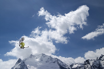 Image showing Freestyle ski jumper with crossed skis