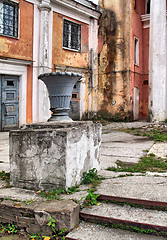 Image showing decorative urn near old buildings