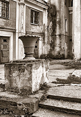 Image showing decorative urn near old buildings