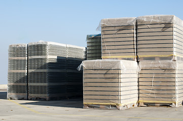 Image showing Pallets of empty glass jars