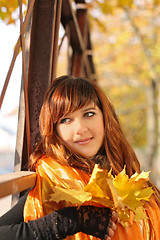 Image showing Beautiful girl with fallen leaves