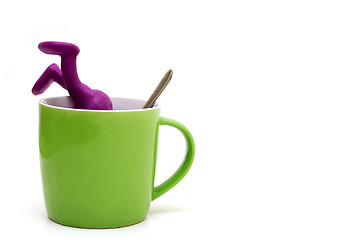 Image showing Purple puppet of plasticine sinking in cup