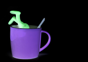 Image showing Shaded puppet of plasticine sinking in cup