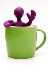 Image showing Purple puppet of plasticine signing from cup