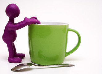 Image showing Purple puppet of plasticine rest on cup