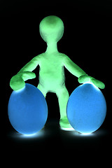 Image showing Shaded puppet of plasticine holding two eggs