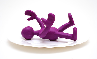 Image showing Purple puppet of plasticine laying on plate