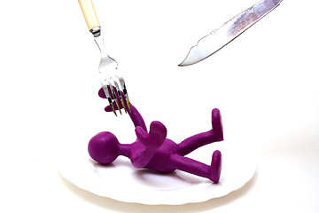 Image showing Purple puppet of plasticine laiyng under threat