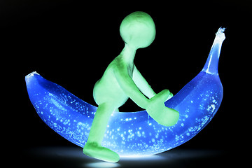 Image showing Shaded puppet of plasticine riding on banana