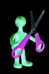 Image showing Shaded puppet of plasticine holding green scissors