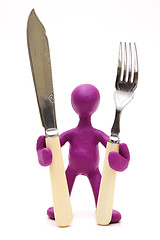 Image showing Purple puppet  standing with tableware