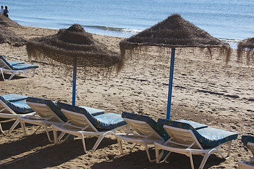 Image showing sunbeds and parasols