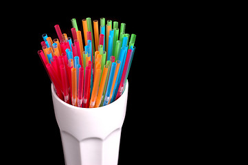 Image showing Colorful straws in white glass