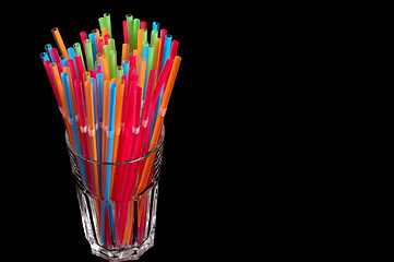 Image showing Colorful straws in clear glass