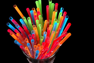 Image showing Close-up of colorful straws in clear glass