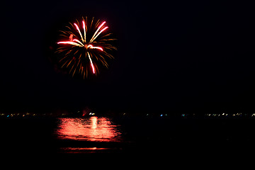 Image showing Fireworks Over Water with Reflections