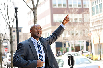 Image showing Business Man Hails a Taxi